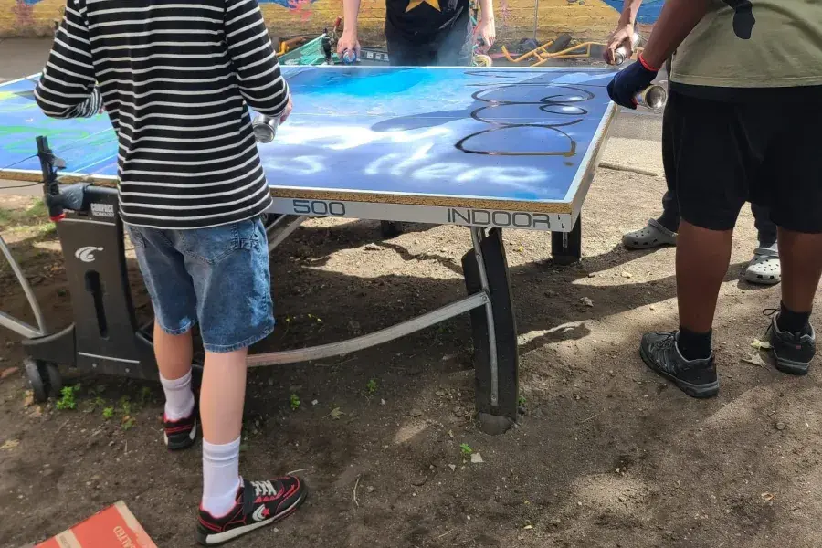 Young people making graffiti