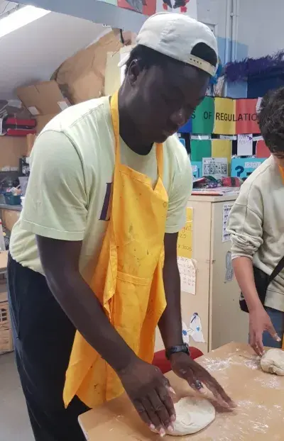 A young adult baking Cinnamon buns