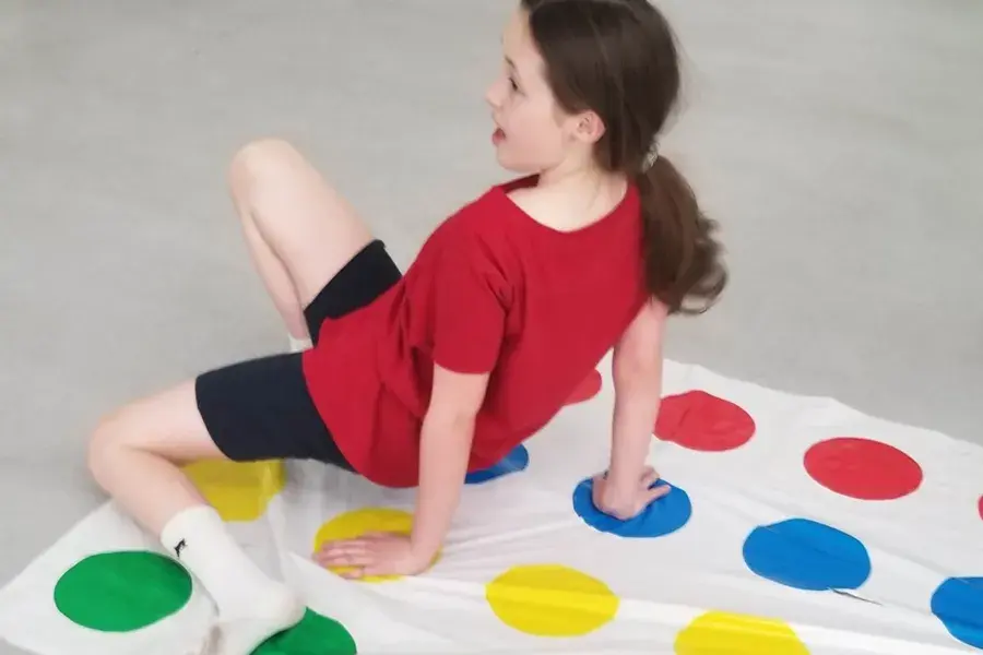 A child playing Twister at My Tribe Junior