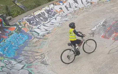 A young person cycling in a skate park